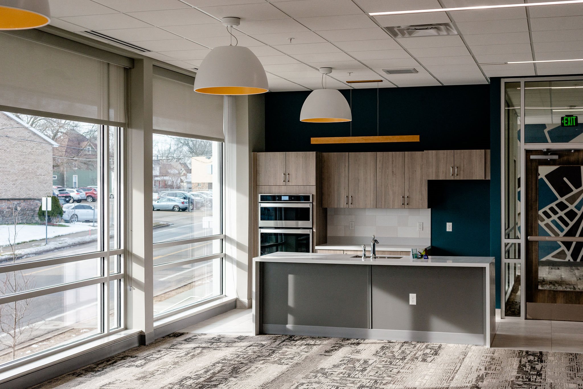 community room with modern kitchen and carpeting